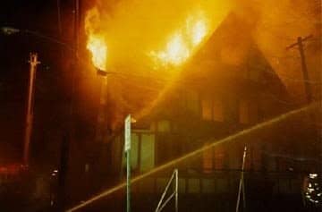 A fully involved house fire at night