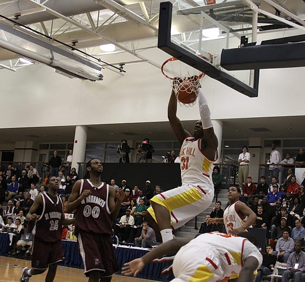 A high-school player throwing down a dunk