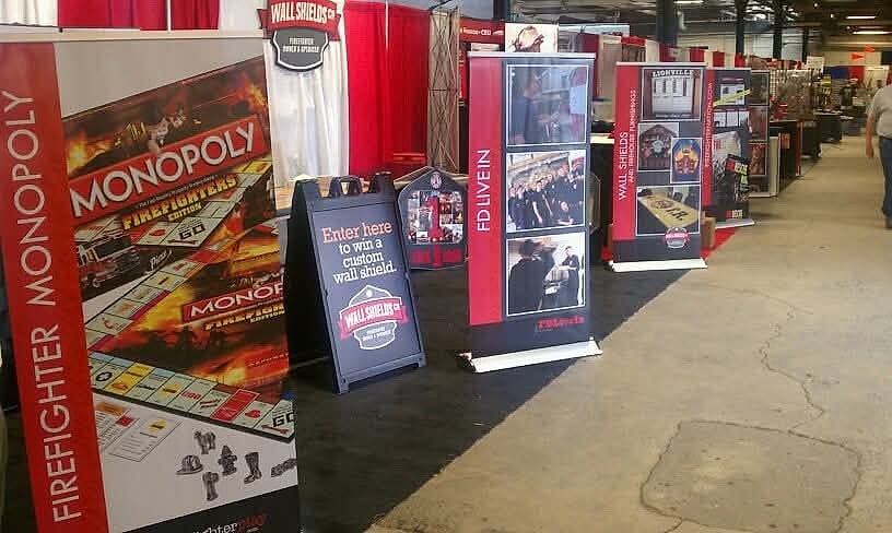 An aisle of booths at a Firehouse Expo trade show
