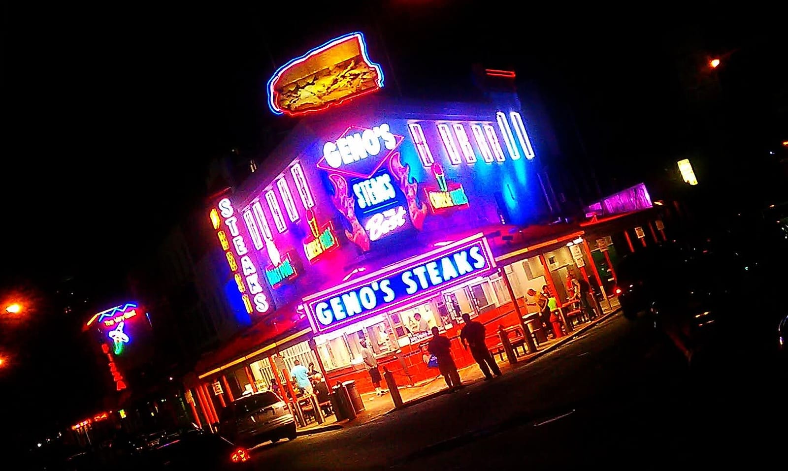 Geno's Steaks in neon at night