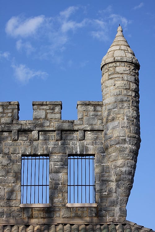 A stone castle turret against a blue sky