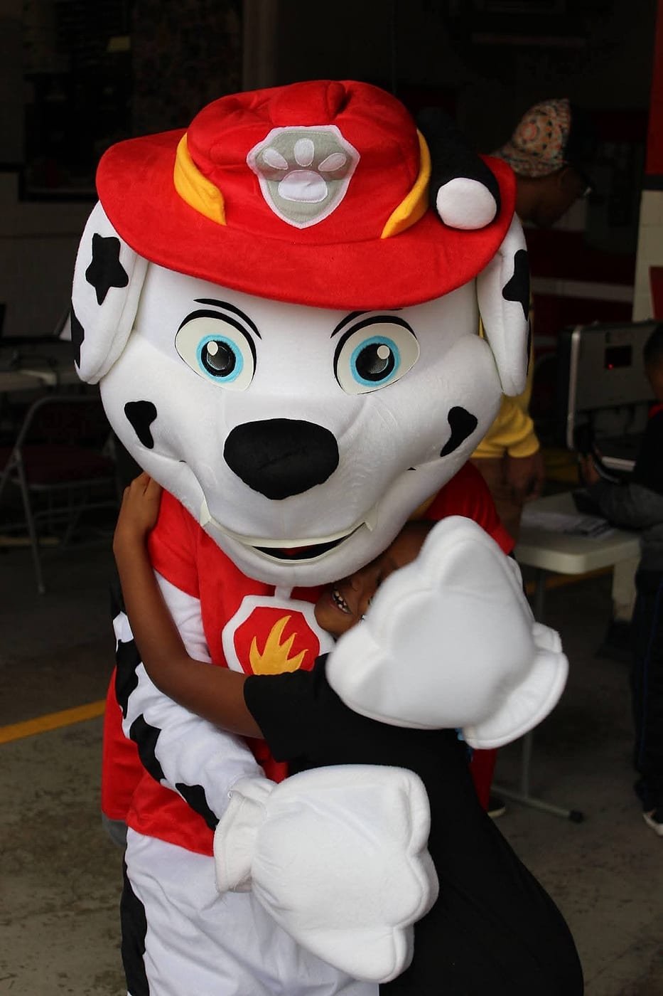 Marshall the fire dog greeting a child at a Hyattsville event