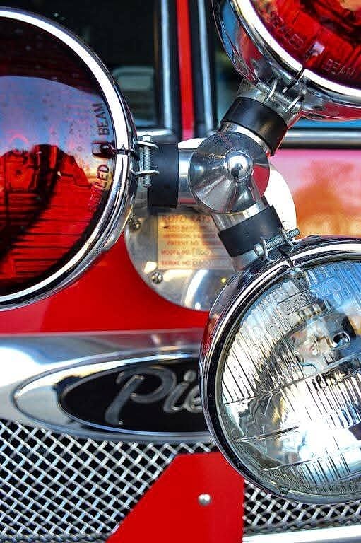 Chrome headlights and grille of a Pierce fire engine