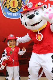 Marshall from PAW Patrol with a young fan at the firehouse