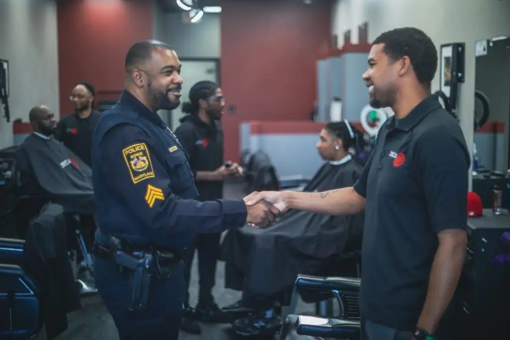 A police officer greeting a barber during a community visit