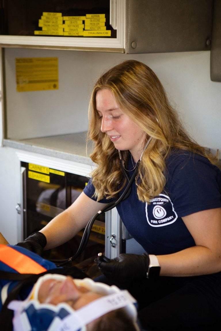 An EMS provider assessing a patient in an ambulance