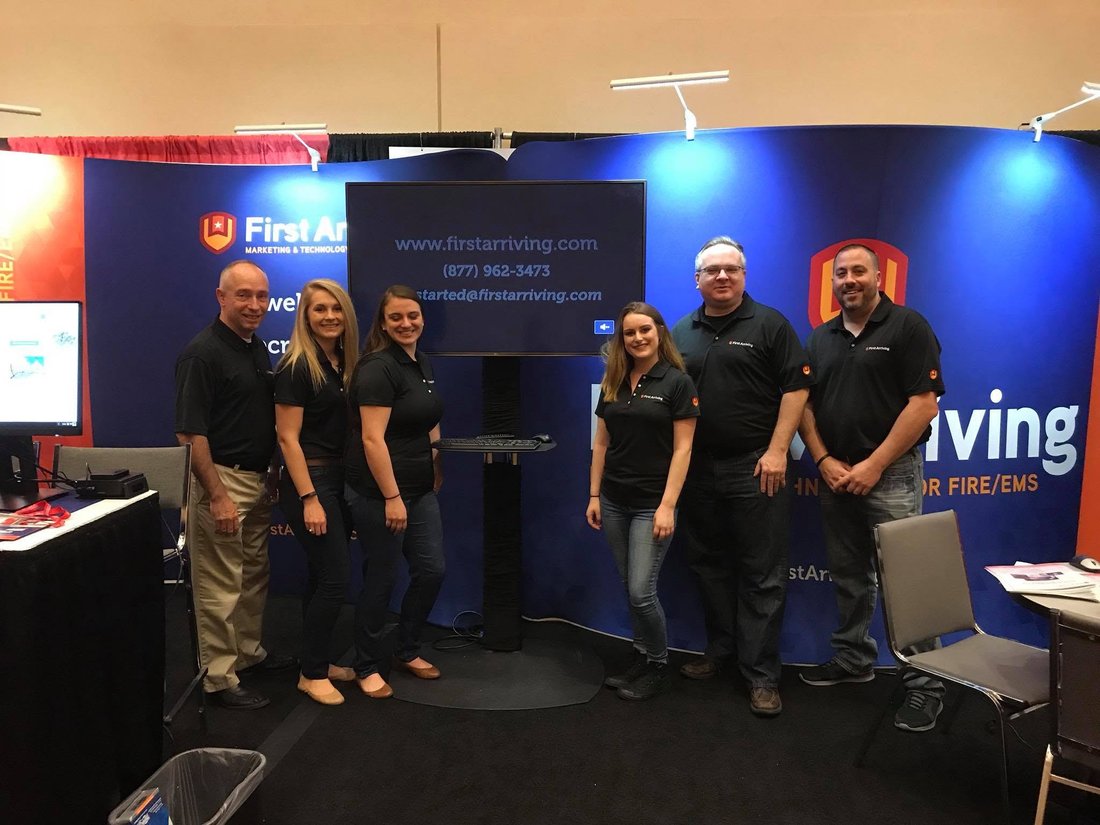 The First Arriving team at a trade show