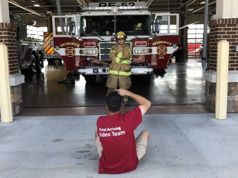 A video team filming a firefighter at the station